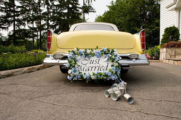 Why are Cans and Shoes Dragged Behind a Wedding Car